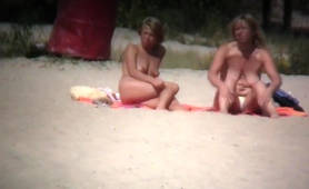 two-busty-milfs-expose-their-wonderful-bodies-on-the-beach
